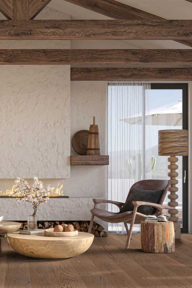 textured wall fireplace in living room with hardwood floors, wood textures, and natural wooden beams